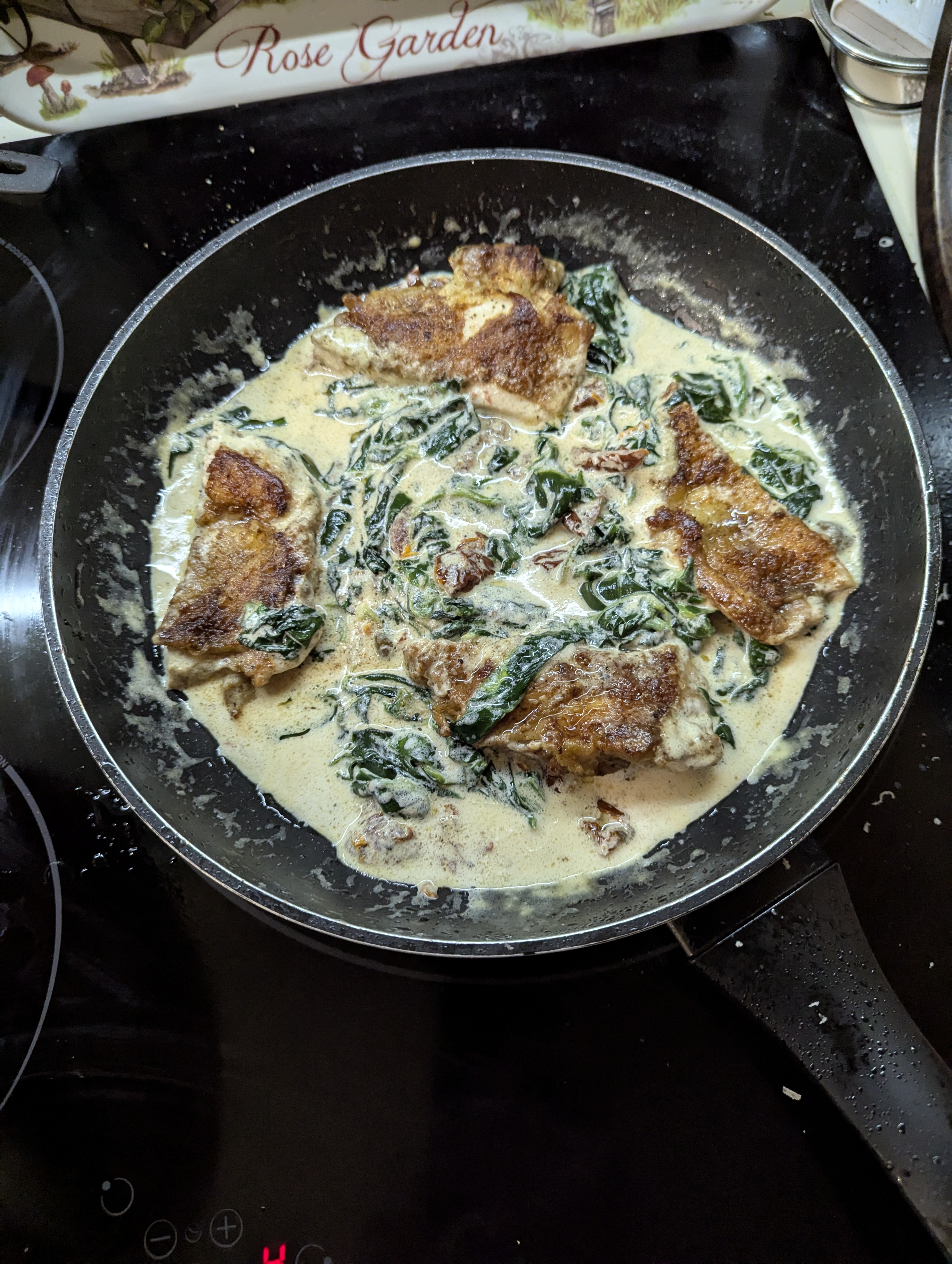 Chicken thighs in creamy sauce of spinach and parmesan